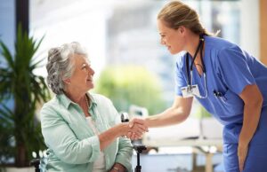 Older adult and family member touring a bright assisted living apartment with a staff guide.