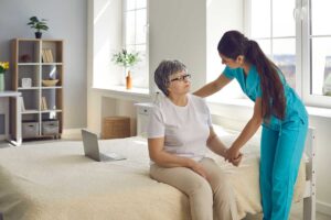 Senior resident and caregiver reviewing a personalized care plan at a table in a bright assisted living room